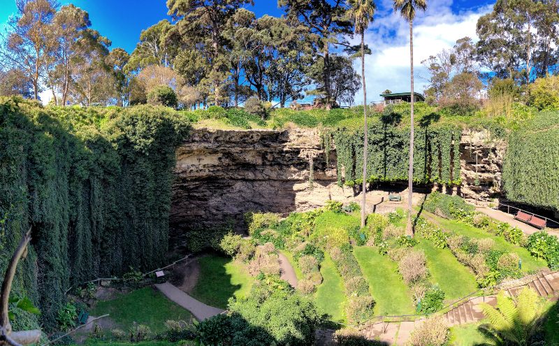 Umpherston Sinkhole Park in Mt Gambier, Australia. Panoramic view on a sunny day.