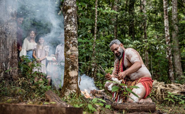 Aboriginal man performing a smoking ceremony in Cairns 