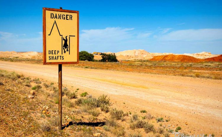Sign warning of dangerous deep mine shafts in Coober Pedy South Australia 