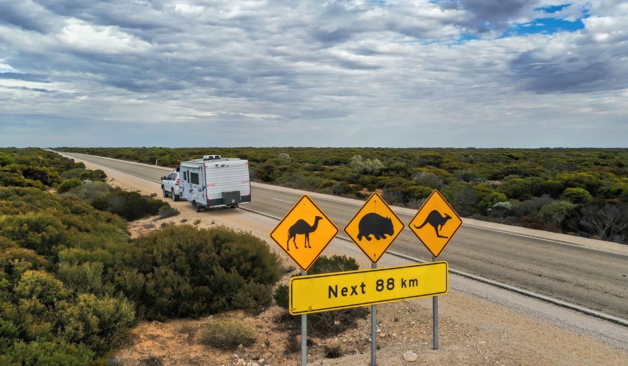 A view of outback Australia travelling on the road with a caravan and 4wd